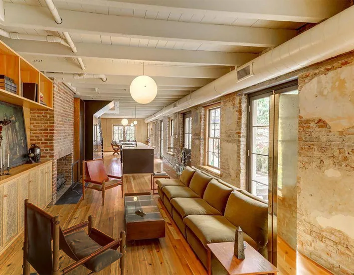 Long shot of living room with exposed brick.